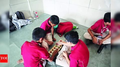 Children playing a board game at Ganitha Mela, from the Times of India report