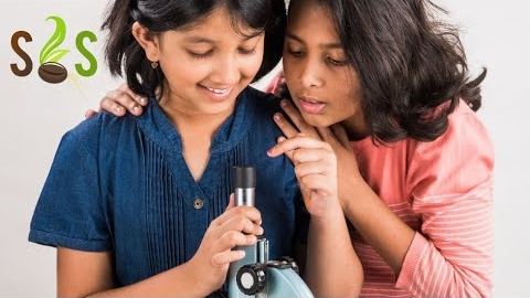 Two students looking into a microscope, from the playlist