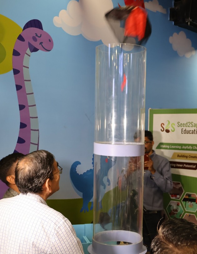 A tall water column exhibit with a spinning vortex inside